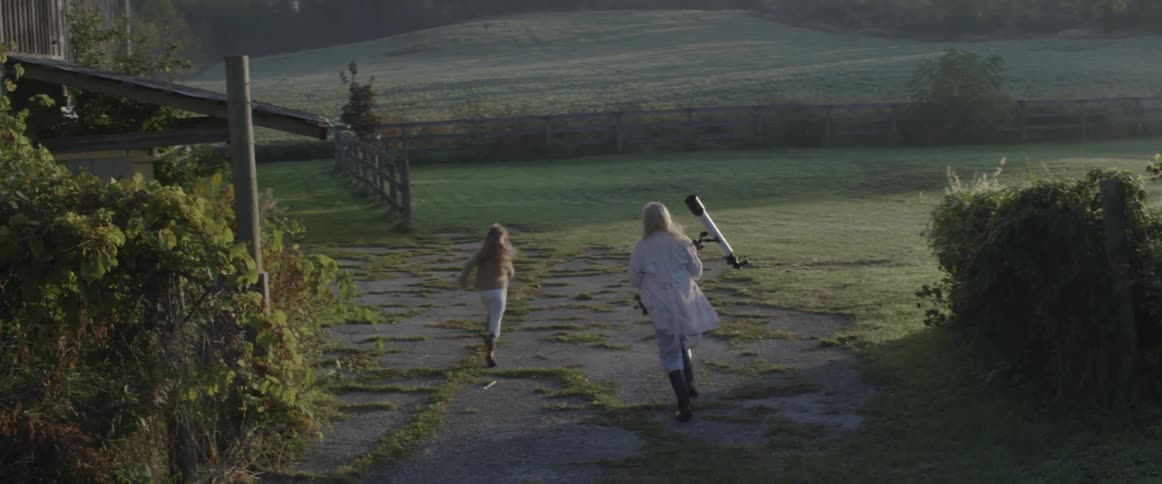 A woman chases after a child carrying a telescope