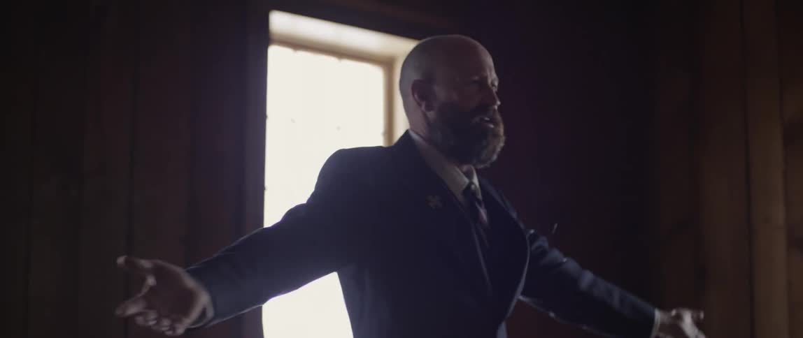 A man walks back and forth waving his arms up and down