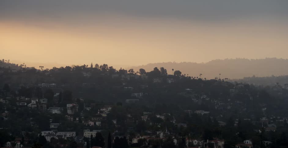 A town is on this hillside covered with fog