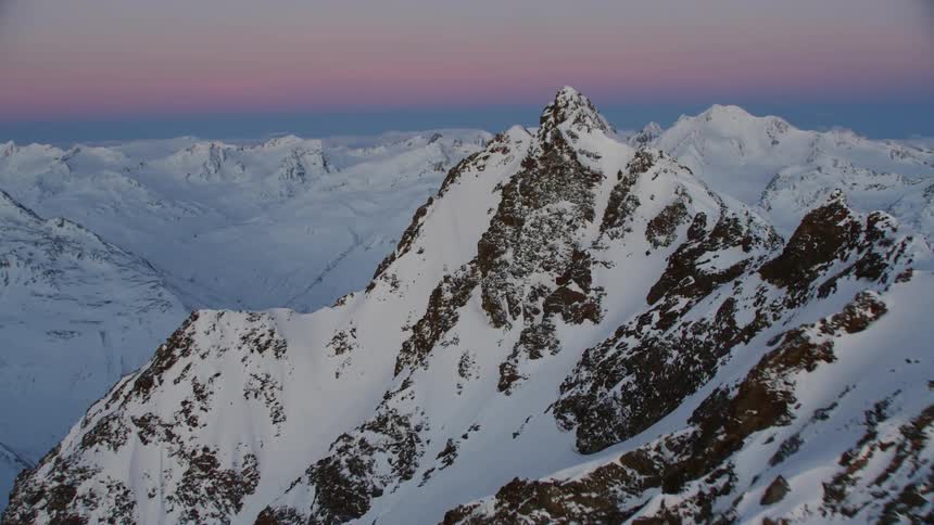 Snowy mountains at sunset