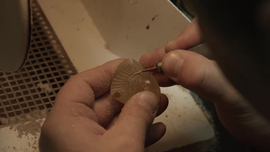 Person carving a piece of stone