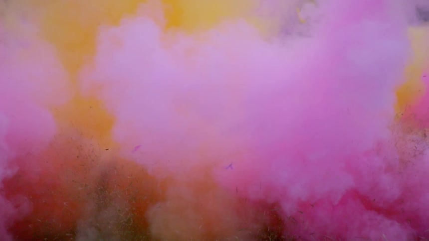 A multi colored smoke bomb explodes