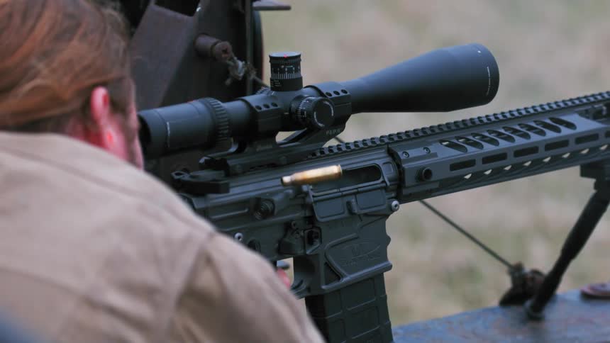 A man fires off his rifle