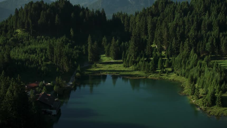 The lake has calm water by the mountain