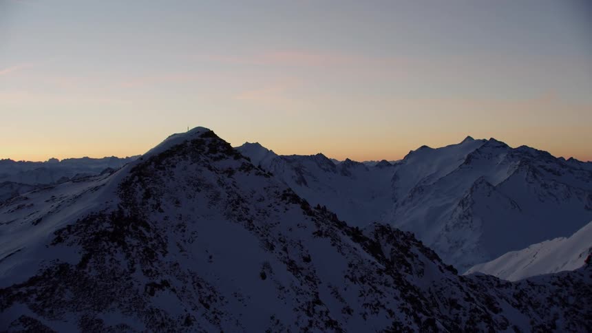 Snowy mountains at sunset