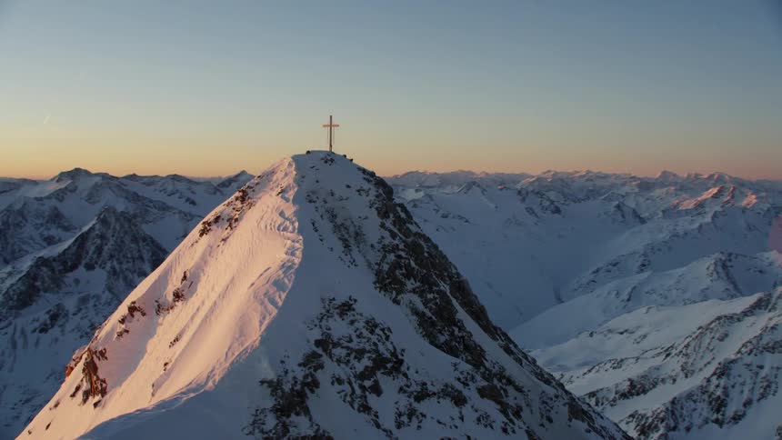 A large cross is on the mountain