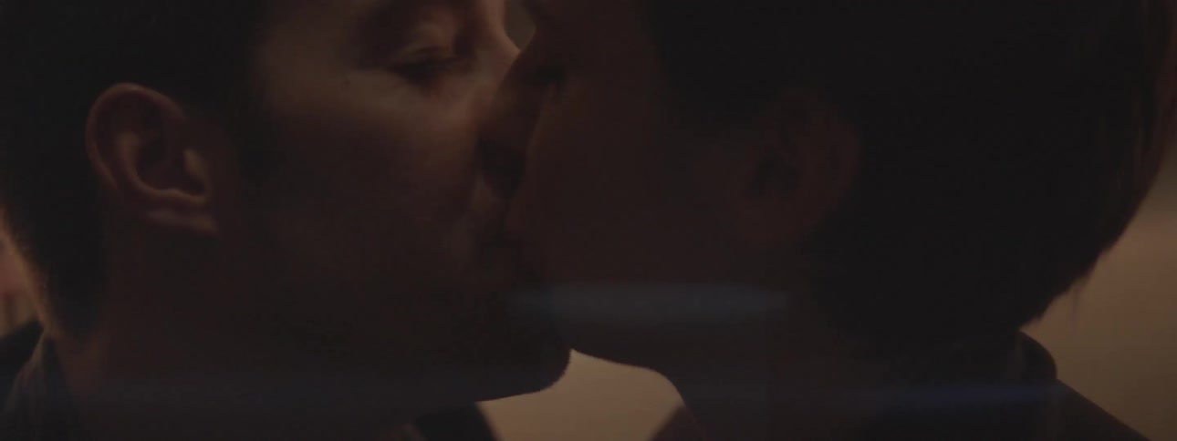 Two people are kissing and smiling