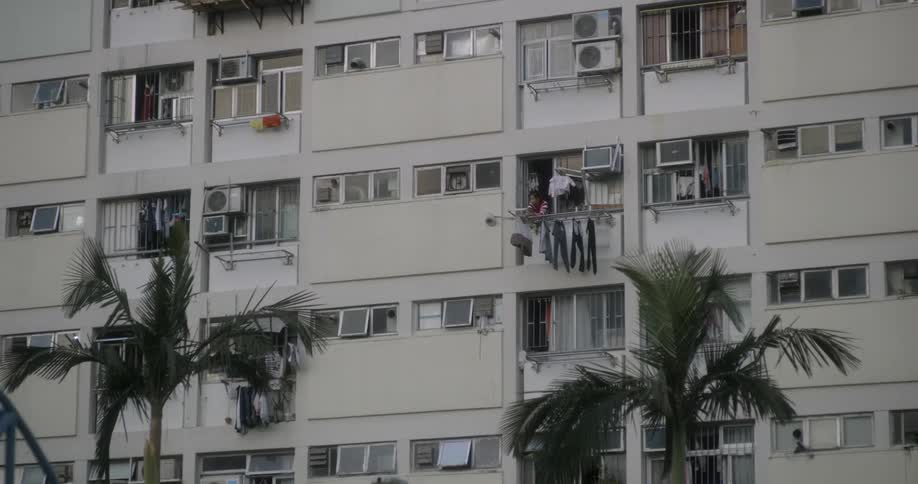 Someone pulling clothes off a clothes line