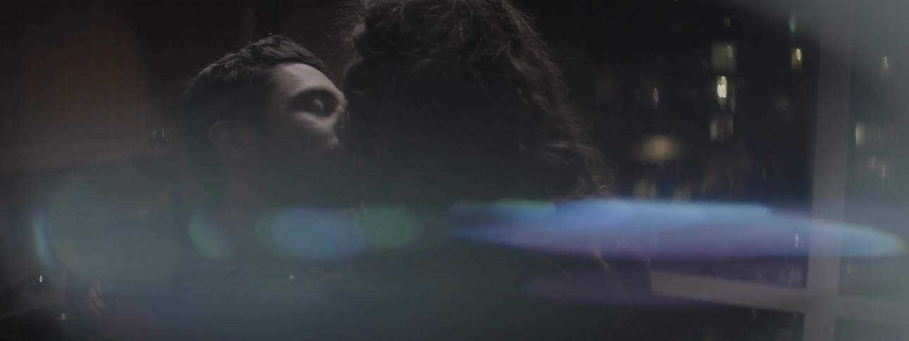 Man and woman nuzzling noses and then kissing