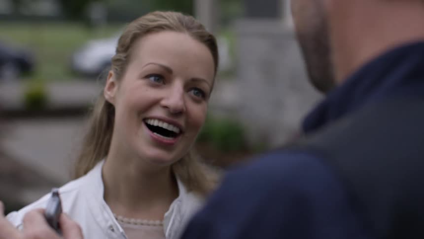 Woman hugs her dad outside after he hands her keys to a car