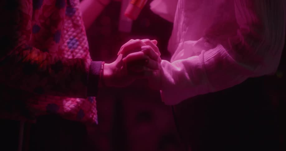 A couple are dancing together holding microphones