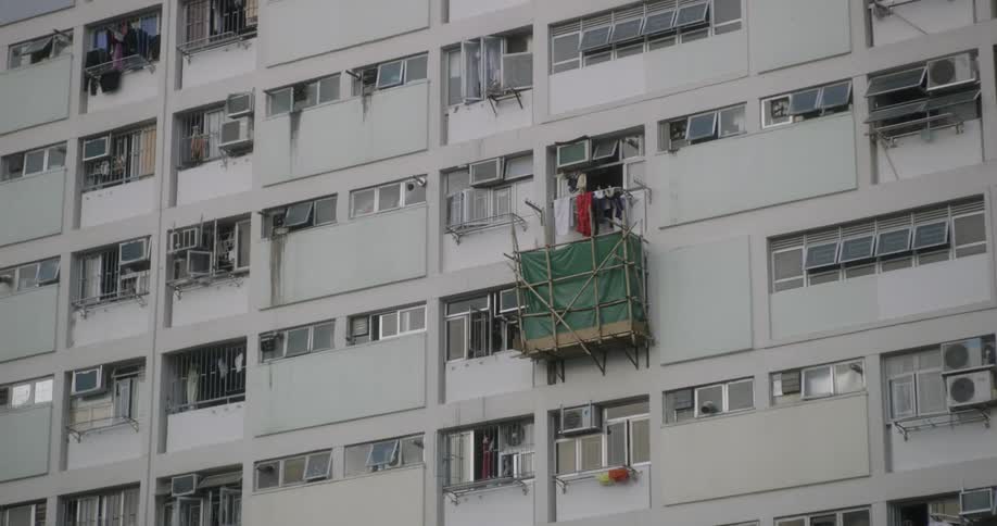 A balcony surrounded by a green tarp