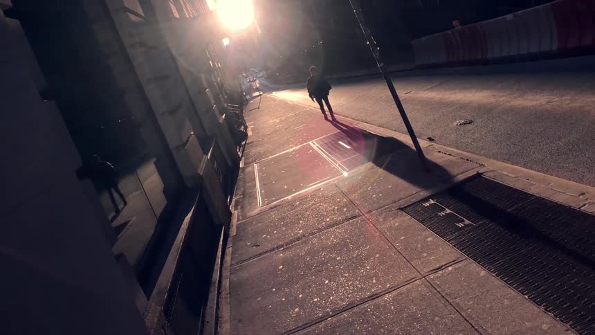 A man walks down a sidewalk