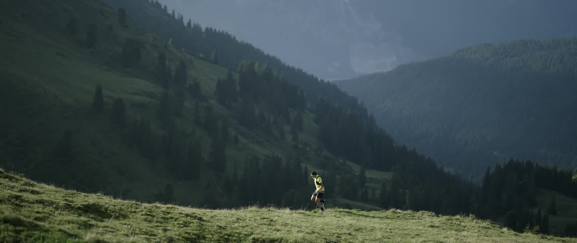 A man runs up a mountainside