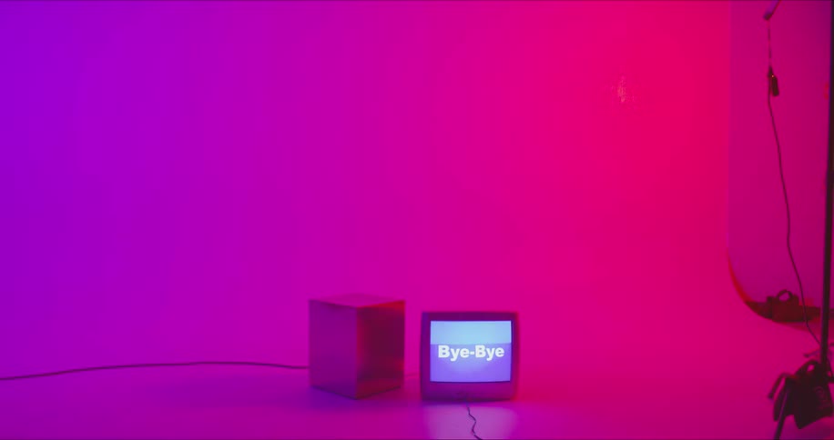 A monitor on the floor flashes the word bye-bye