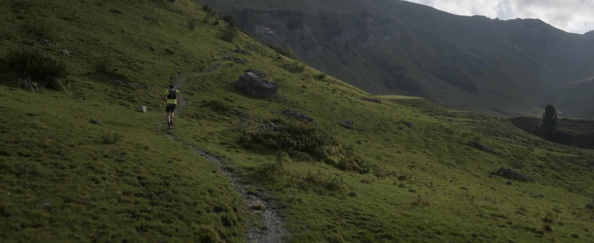 A man runs up a hillside