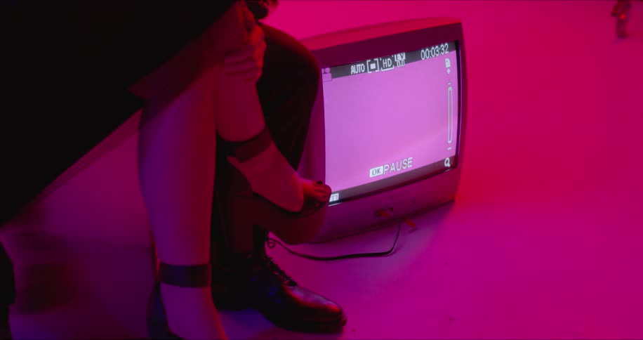A person is sitting near a television