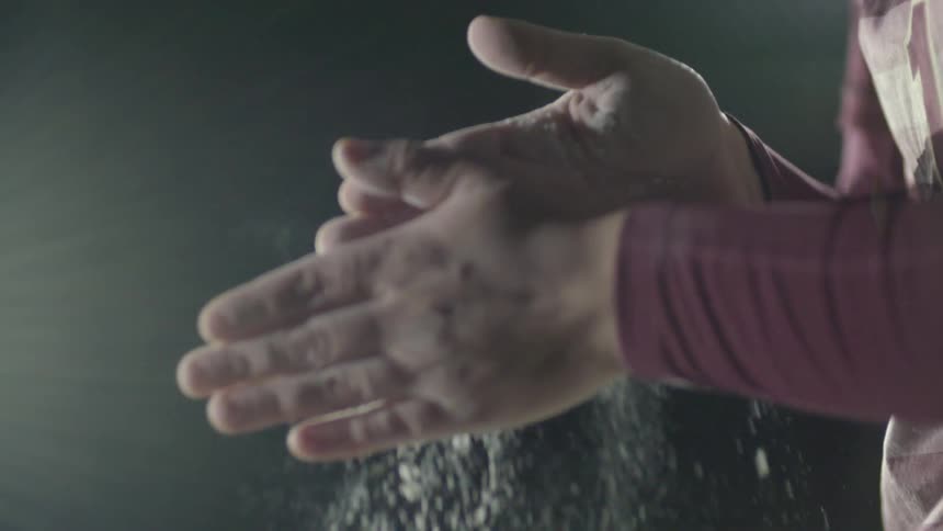 An athlete rubs dust together