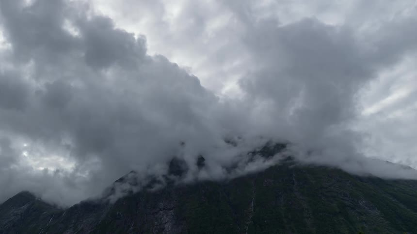Clouds and fog pass through mountains in timelapse