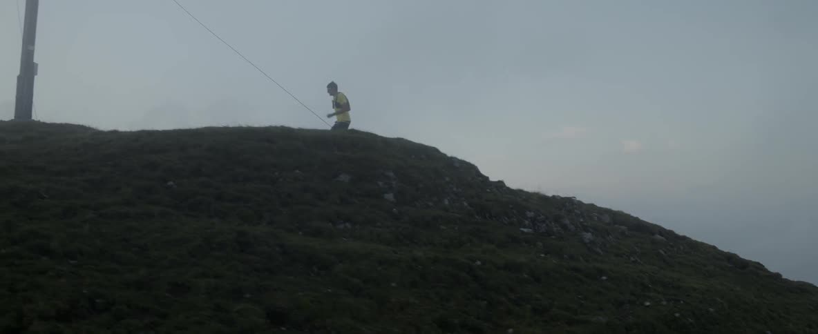 A man is running fast up the mountain at sunset