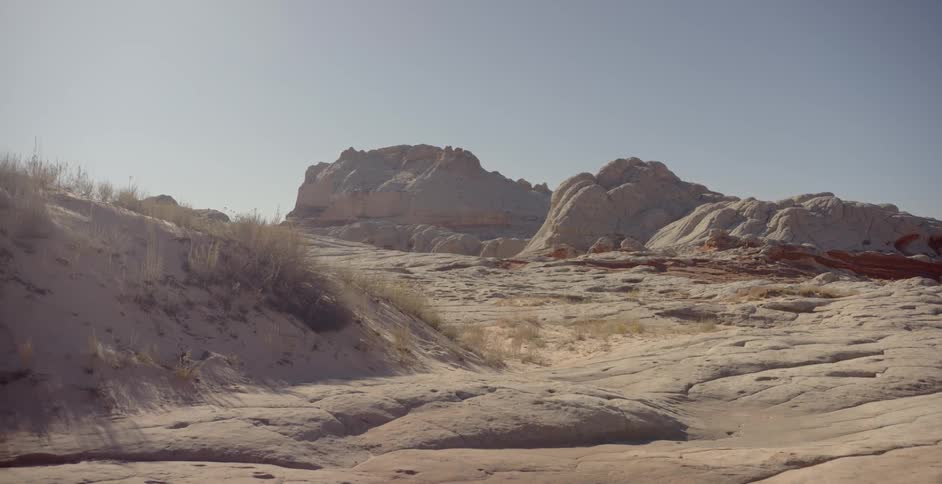 Rock formations stand in the desert on a sunny day