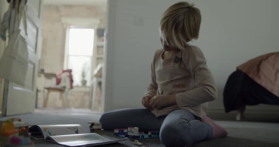 A child is playing in the bedroom