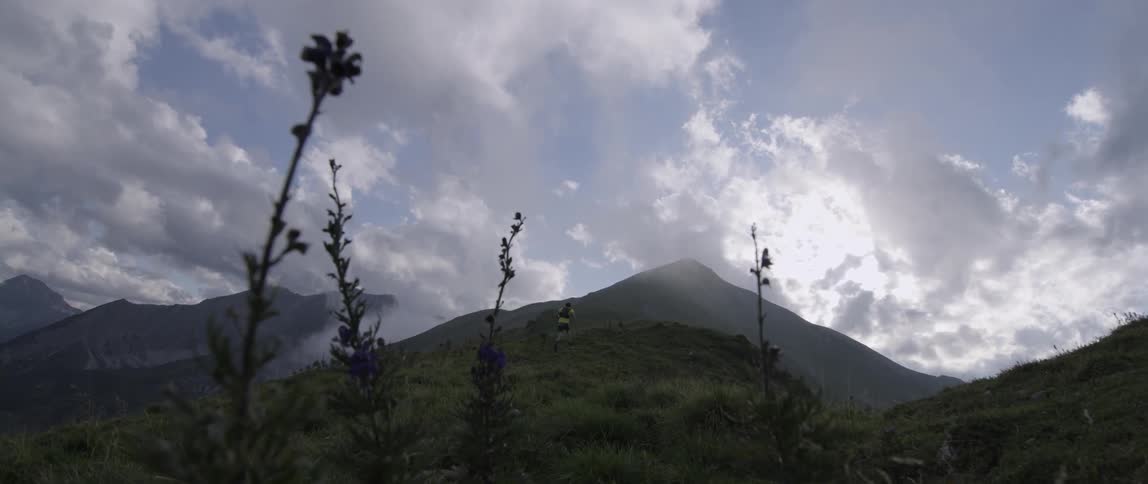 A man hikes uphill running very fast
