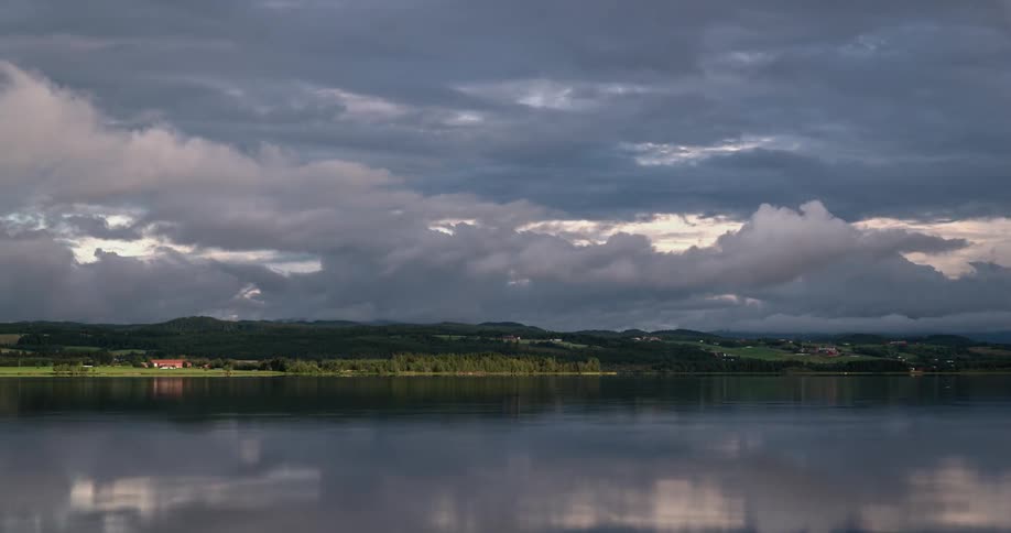 Clouds float over a rippling lake