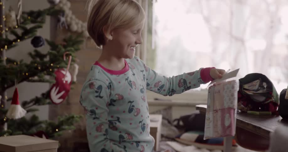A child holds a present up smiling