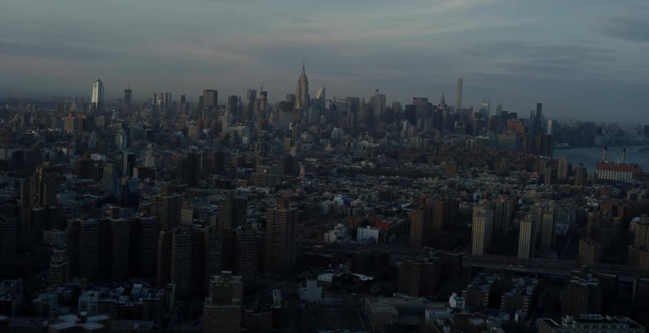 Aerial view of a city with a cloudy sky at dusk