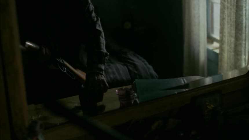 A person begins loading his rifle