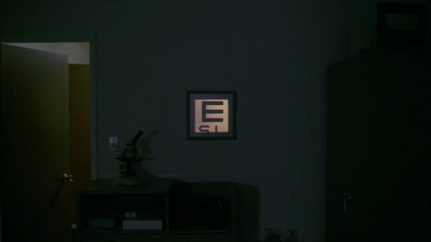 The sign is scrolling in a dark eye doctor office