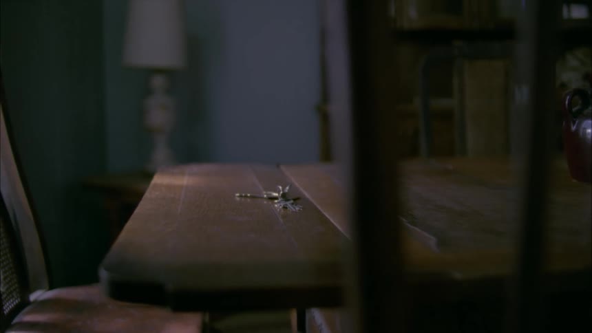 Sun shines through a window onto a key on a table