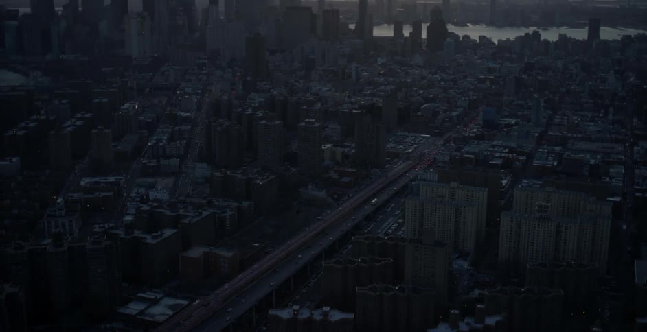 An aerial view of an elevated roadway in a large city
