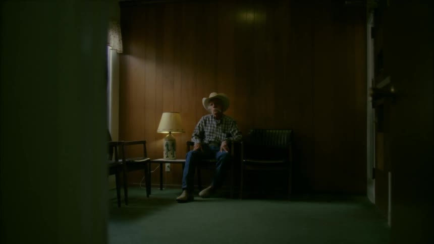 A man sits in a room alone