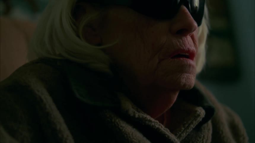 An elderly lady wearing sunglasses
