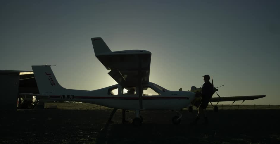 A man guides a small plane forward