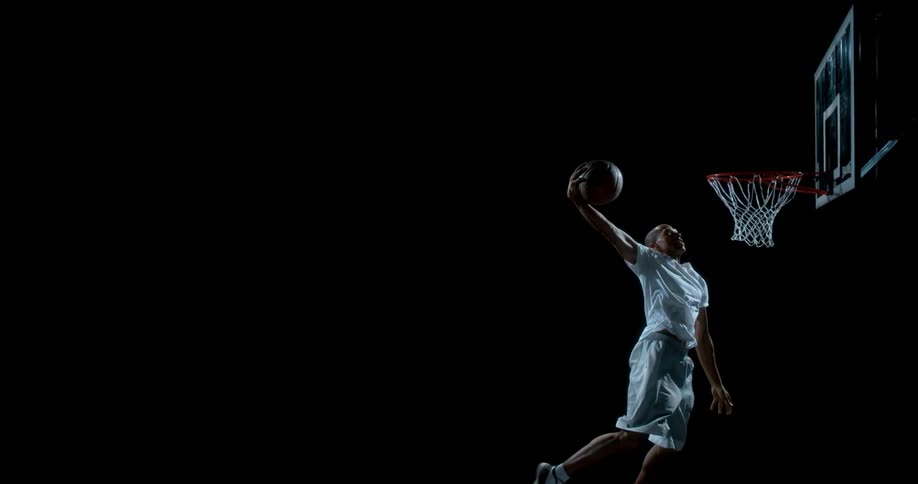 A person dunking a ball in slow motion