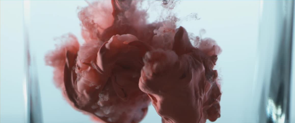 A red ink blob in water