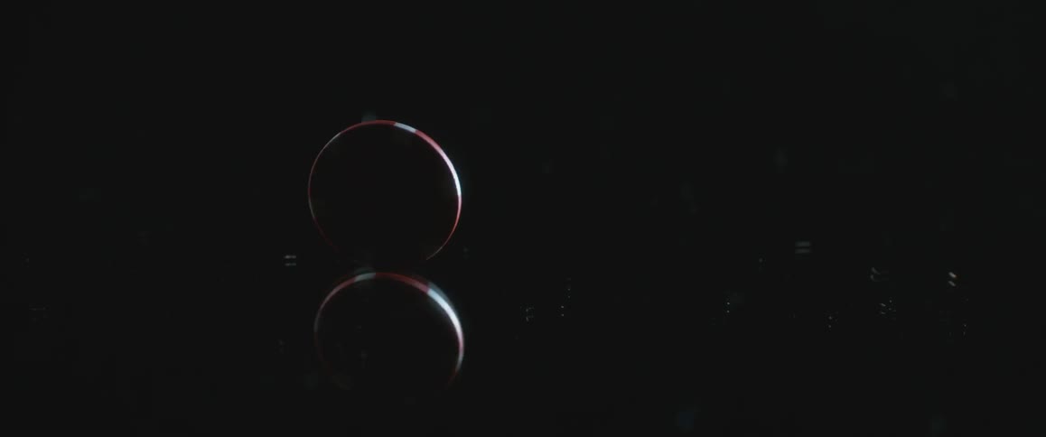 Poker chip spinning round and round on a dark tabletop