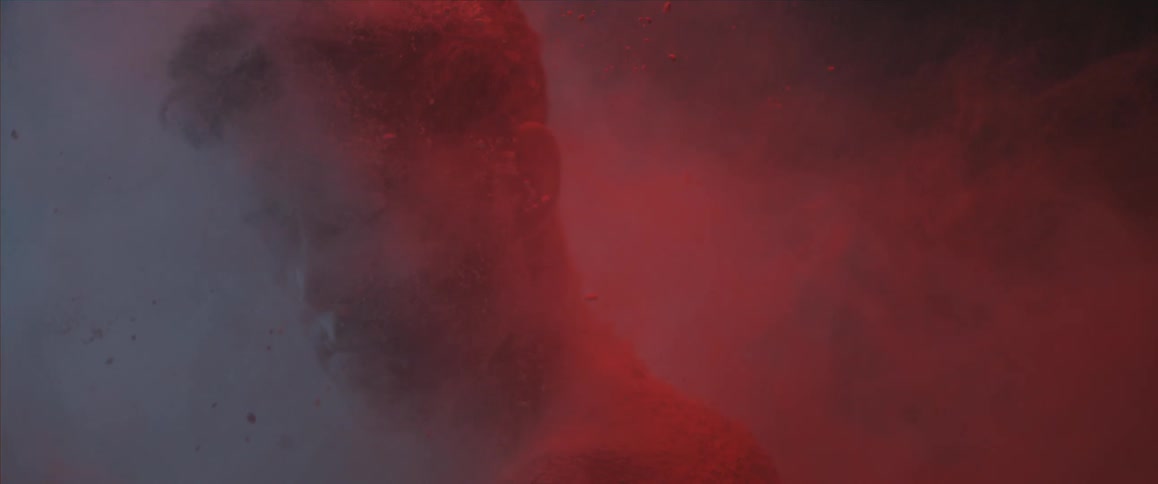 Red dirt hitting all over a mans head and shoulders