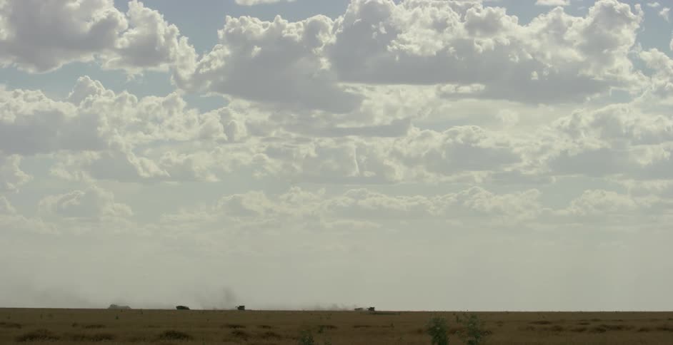 Puffy clouds over a large plains