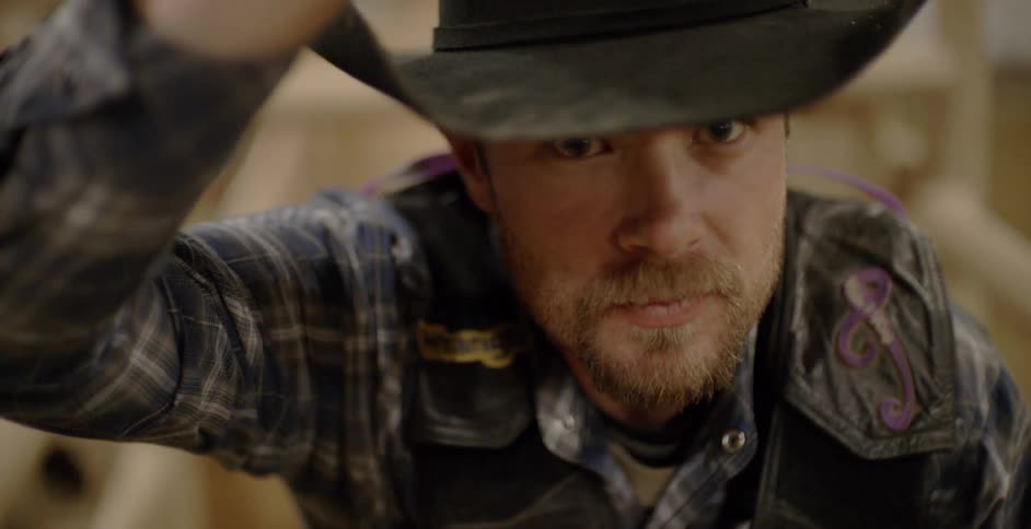 A rodeo cowboy nods as he signals he's ready to go