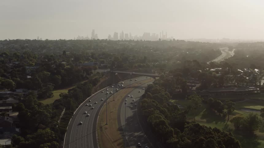 Cars traveling on freeway in large city on smoggy day