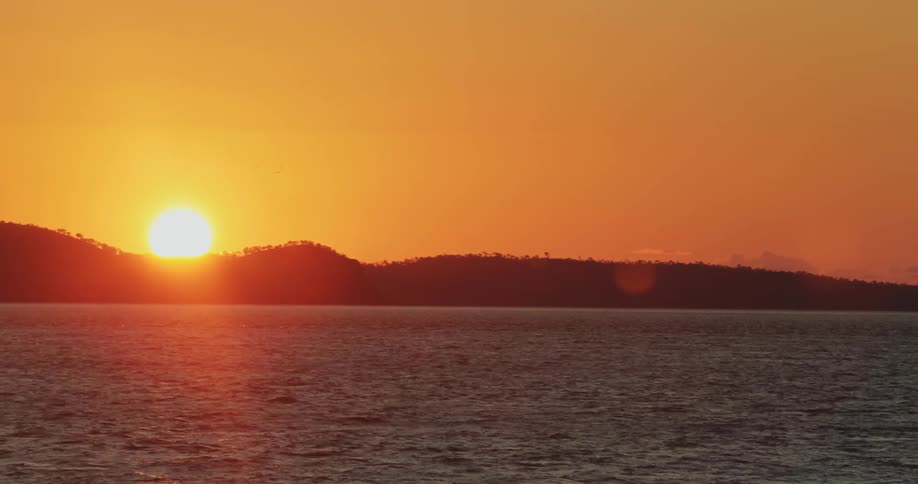 The sun sets over a lake