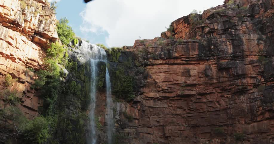 A waterfall cascades over a rocky cliff
