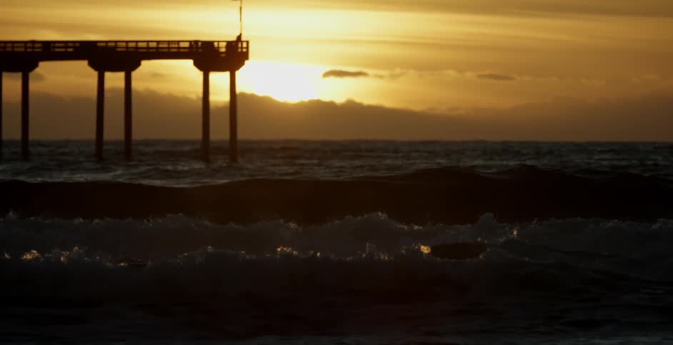 Waves roll under a dock