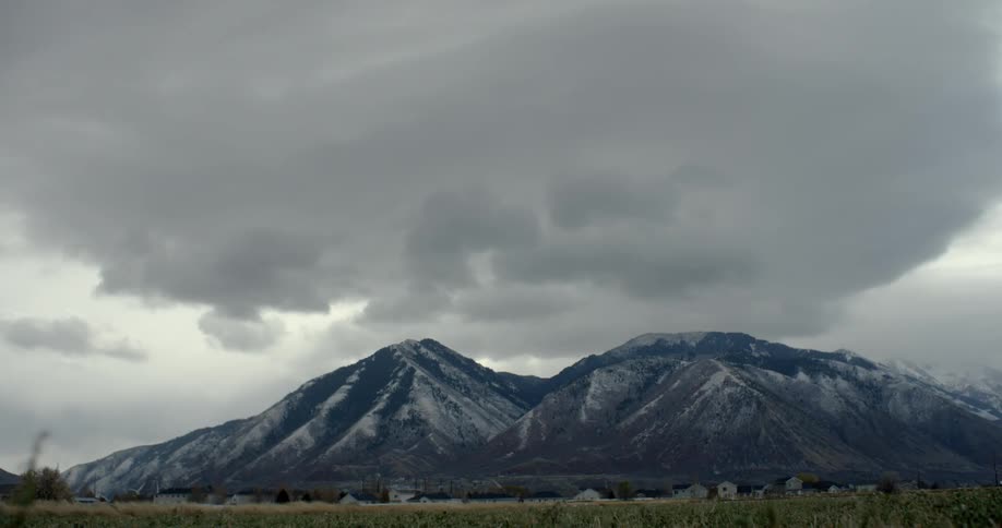 Snow falls near mountains