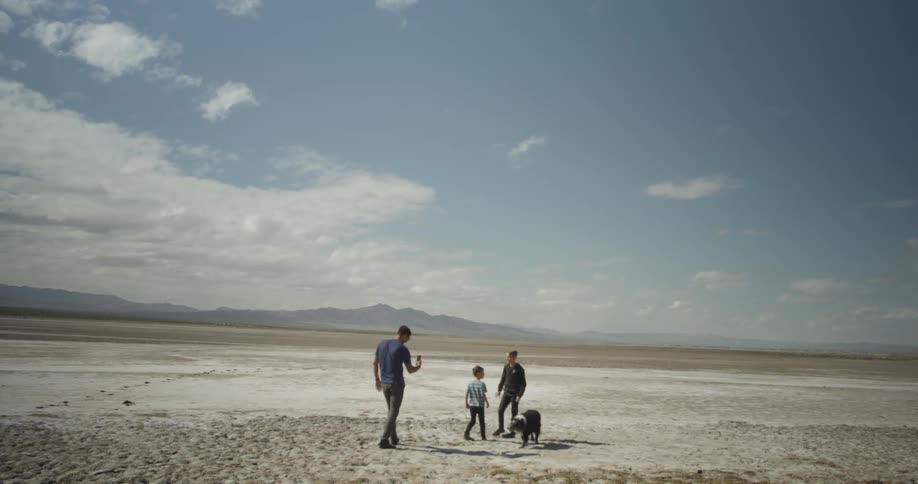 A family play outside with their dog