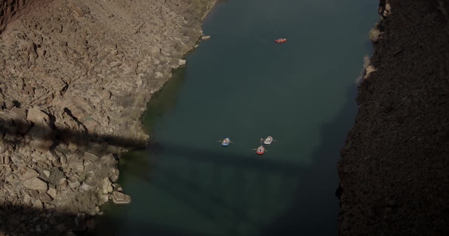 People on rafts floating on river canal
